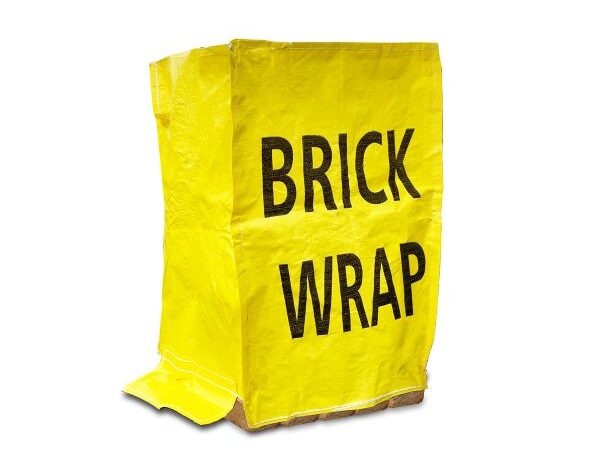Yellow Brickwrap reusable brick cover placed over a pallet of bricks