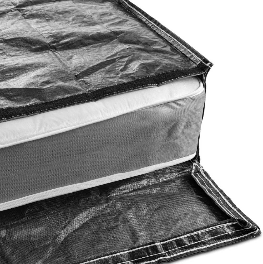Black mattress bag for moving placed on its side with king size mattress showing through the resealable opening.